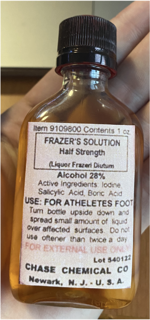 Recreation of a bottle with "Frazer's solution". The label includes directions of use, the name of the manufacturer and the place where it was produced