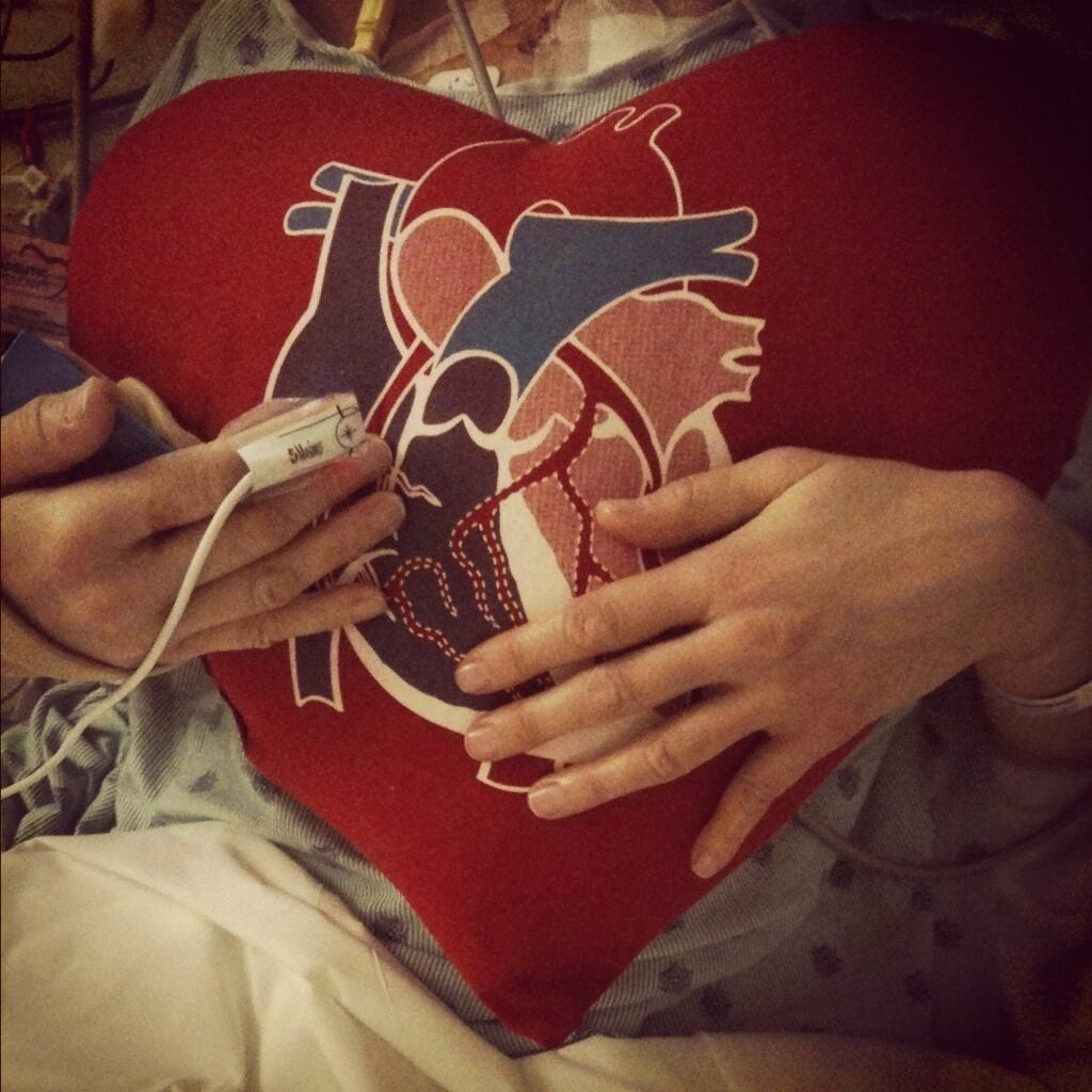 Hospital patient holding a heart-shaped plushie