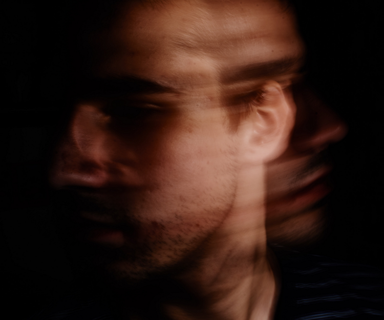 Blurry image of a man looking away