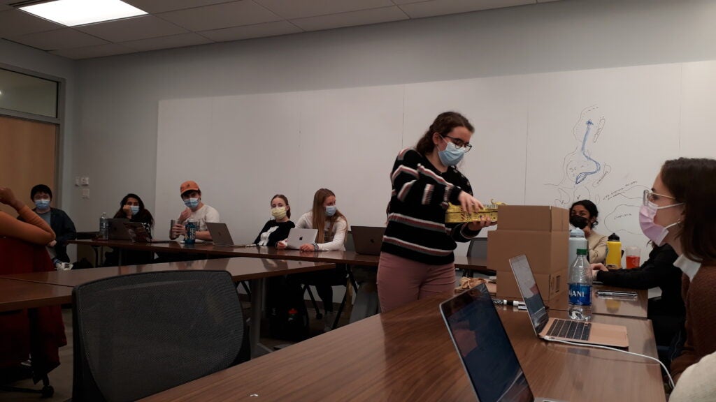 Layan Shahrour displays her project about the usage of plant-based materials in the mummification process in the New Kingdom of Egypt, before the Intro to Medical Humanities class. She is holding a hand-made clay sarcophagus where a mummy would be placed