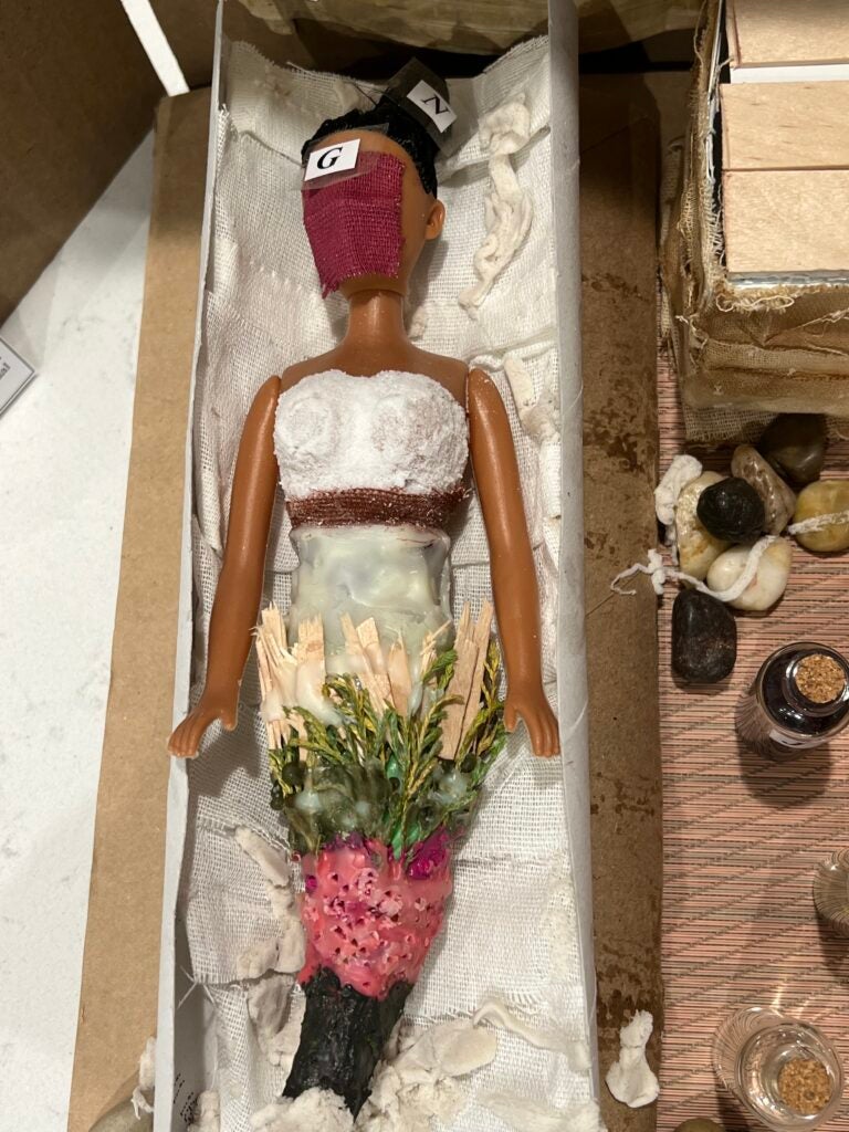 Doll representing the body that would be wrapped as a mummy in a sarcophagus