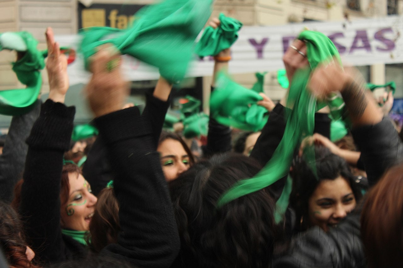 Group of women waving green bandanas in proabortion protest