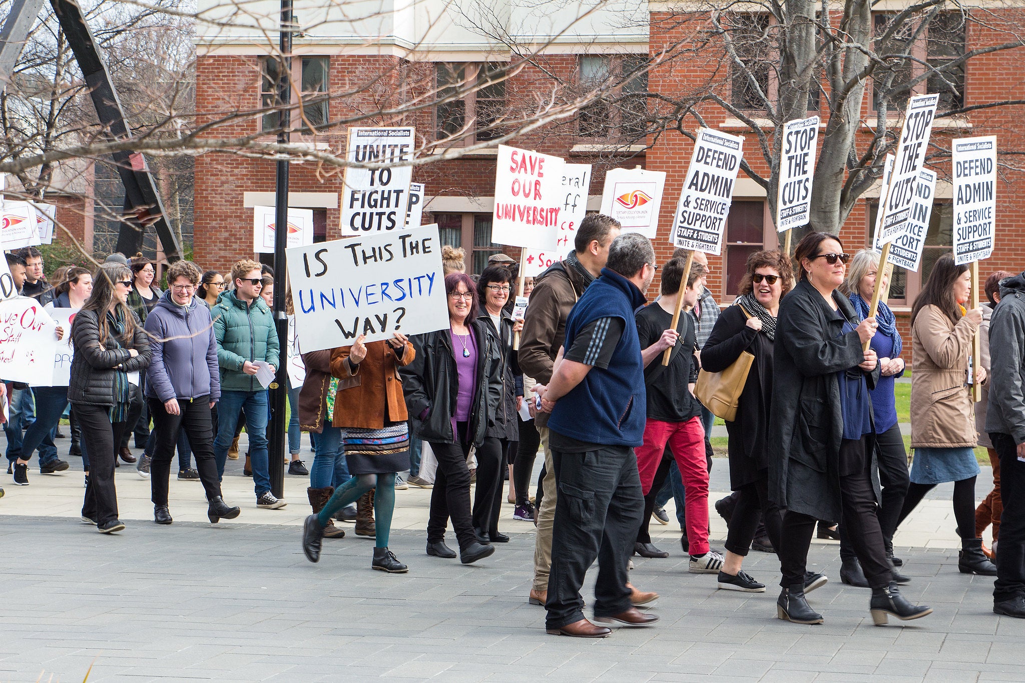 University staff on strike. Their signs say 