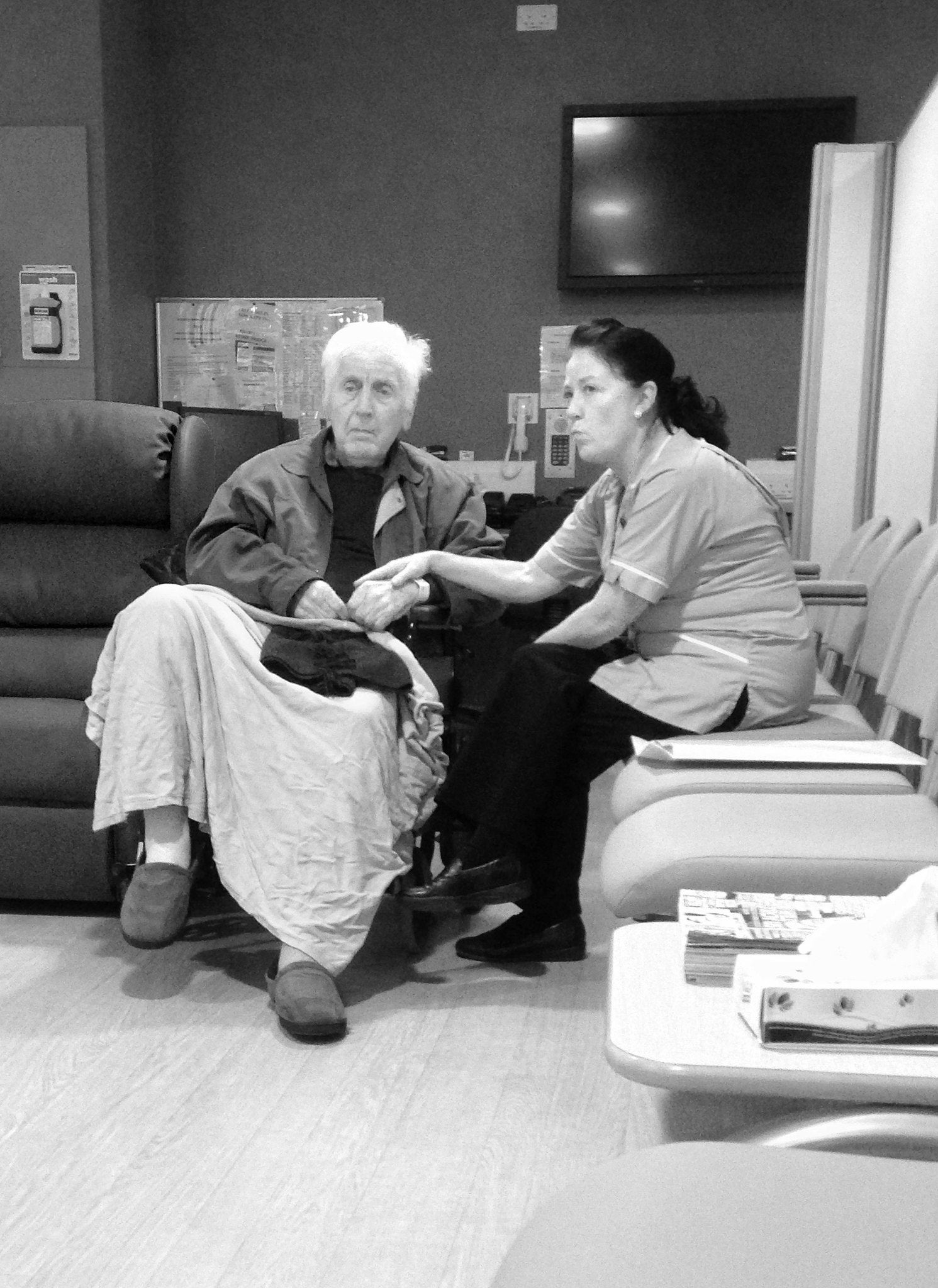 Nurse holding patient's hand
